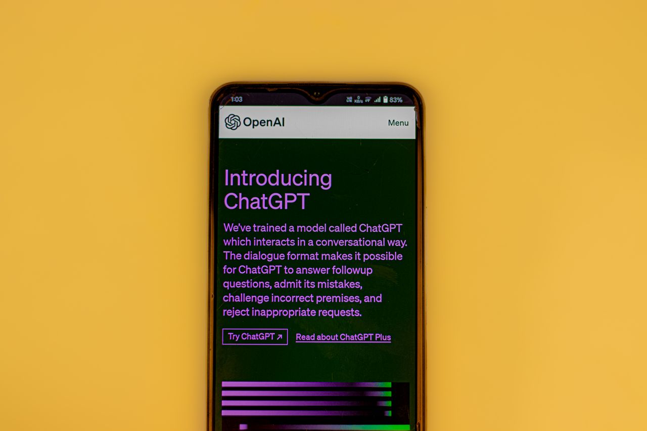 about-img Mobile phone displaying the ChatGPT introduction screen with OpenAI branding on a yellow background.